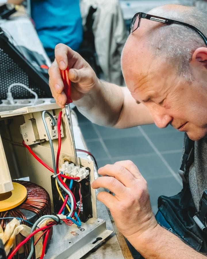 Daniel Brightwell, founder of Brightwell Electrical, working on a consumer unit