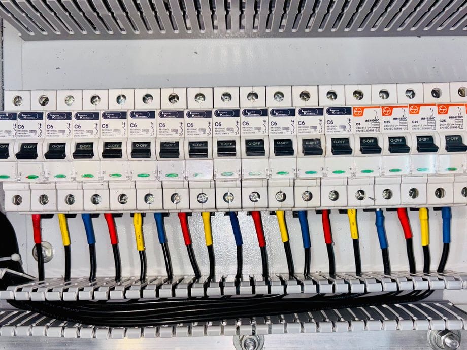 Tidy three-phase distribution board with labelled, colour-coded circuits