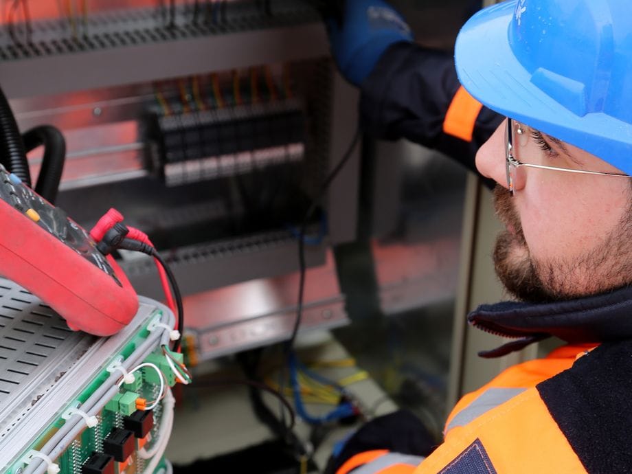 Electrician in safety gear making an electrical fault safe on a call-out